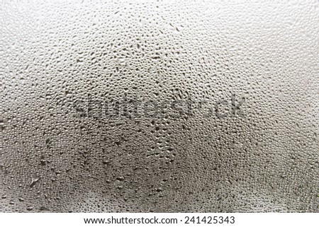 Misted window glass in drops of water as a background