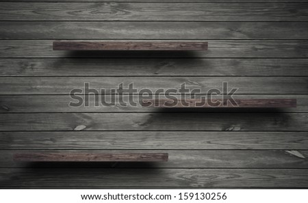 Antique wooden shelf on old wooden wall