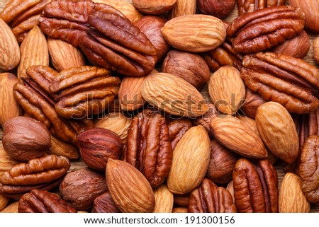 Background texture of assorted mixed nuts including cashew nuts, pecan nuts, almonds