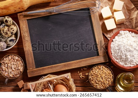 Ingredients for baking on wooden background with place for text. Top view.
