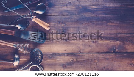 Vintage kitchen items on wooden background.