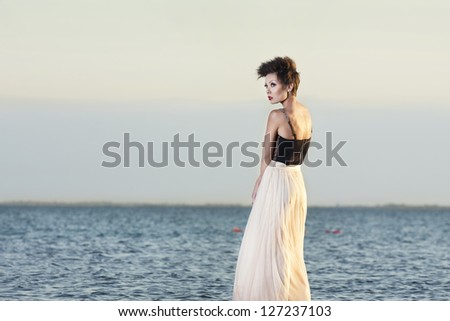 the beautiful girl costs on among the lake alone