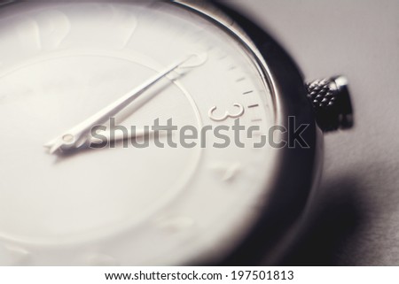 Old watch on a grunge sepia background