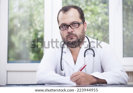 Doctor working on a digital tablet and touching the screen