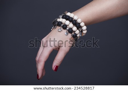 Woman\'s hand with bracelet and beads
