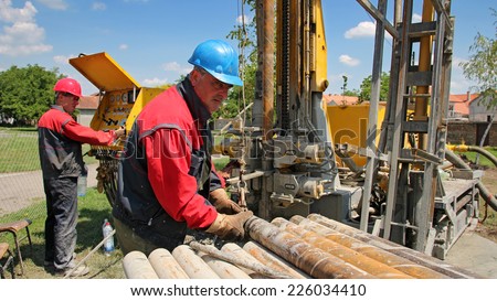Oil Workers at Work. Oil and gas industry. Oil drilling rig workers lifting drill pipe. Power and energy.