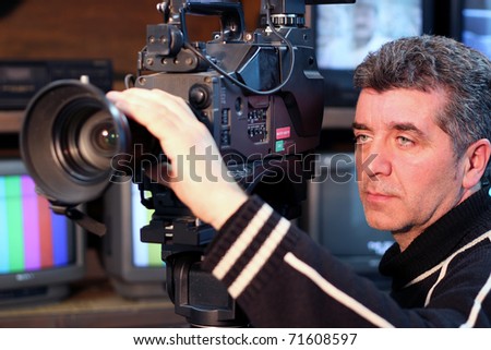 Camera operator using a television camera.