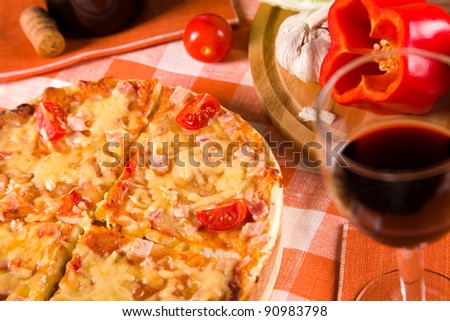 sliced pizza and glass of red wine