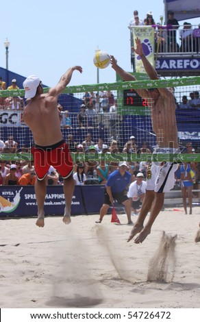 HUNTINGTON BEACH, CA - JUNE 6: Todd Rogers spiking against the block or Sean Scott in the finals of the AVP pro beach volleyball tournament June 6, 2010 in Huntington Beach, CA