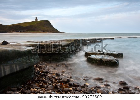 A slow shutter landscape shot of the tide coming in over the rocks at Kimmeridge Bay in Dorset, UK.