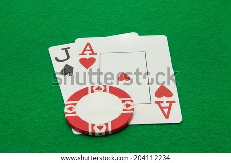 Jack and ace blackjack hand cards with chip on green background
