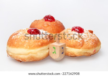 Hanukkah doughnut and spinning top - Traditional jewish holiday food and toy.