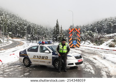 Safed, Israel - February 20, 2015 : Israeli Police road block on the main road leading to Safed, due to heavy snow storm that hit Israel during the weekend of February 20th.
