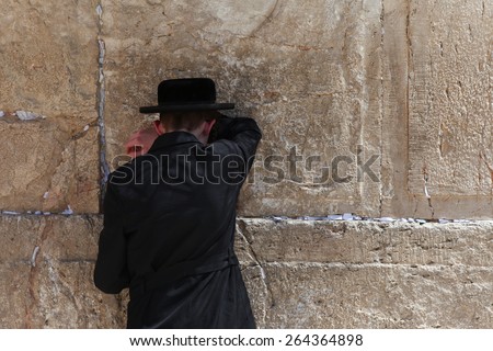 Jerusalem, Israel - March 24 2015 : Orthodox Jewish man pray at the western wall. The western wall is an exposed section of ancient wall situated on the western flank of the Temple Mount.