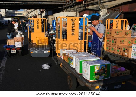 Tokyo, Japan - May 10, 2015: Workers at Famous Tsukiji fish market operational area. Tsukiji is the biggest fish market in the world, with a vast varaiety of Fish and sea food.