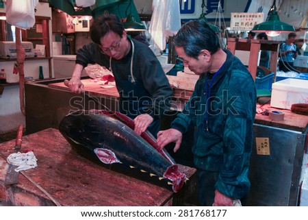 Tokyo, Japan - May 11, 2015: Fresh Tuna main cut by professional Japanese tuna handlers at Tsukiji fish and seafood market, right after the Tuna auction.