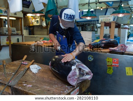Tokyo, Japan - May 14, 2015: Fresh Tuna main cut by professional Japanese tuna handler at famous Tsukiji fish and seafood market, right after the Tuna auction.