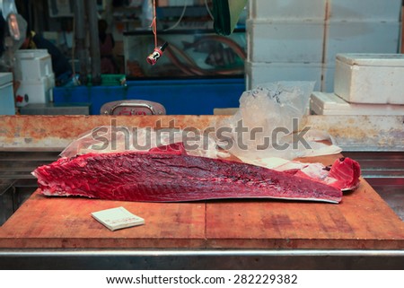 Tokyo, Japan - May 11, 2015: Fresh Tuna main cut by professional Japanese tuna handlers at Tsukiji fish and seafood market, right after the Tuna auction.