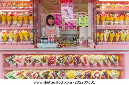 Tokyo, Japan - May 14, 2015: Crape and ice cream vendor at Harajuku\'s Takeshita street, known for it\'s Colorful shops and Punk Manga - Anime overall look.