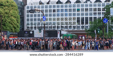 Tokyo, Japan - May 11, 2015: Pedestrians at Shibuya crossing, The famous scramble crosswalk also known as Shibuya scramble is used by over 2.5 million people on daily basis.