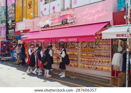 Tokyo, Japan - May 14, 2015: Crape and ice cream vendor at Harajuku\'s Takeshita street, known for it\'s Colorful shops and Punk Manga - Anime overall look.