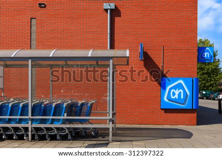 Amsterdam, The Netherlands - August 22, 2015: Albert Heijn Store front with logo and shopping carts, Albert Heijn is the largest supermarket chain stores in Holland