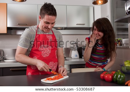 Couple cooking and having fun together in kitchen.