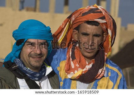 MERZOUGA, MOROCCO - OCTOBER 21: Portrait of Berber men in the Sahara with turban head garb blowing in the wind on October 21, 2011 Merzouga, Morocco.