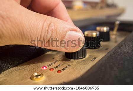 Fingers adjusts fine-tune controls of retro style  speaker. Selective focus Photo stock © 
