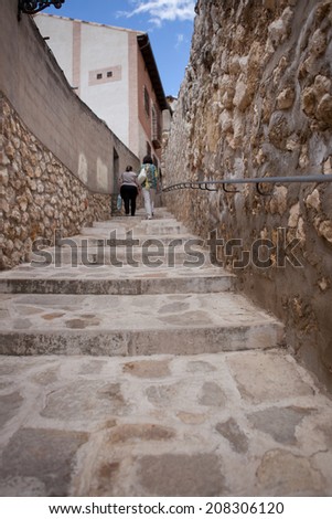 PASTRANA, SPAIN: 20 JULY: two women climbing the narrow streets of Pastrana, Guadalajara. On july 20, 2014