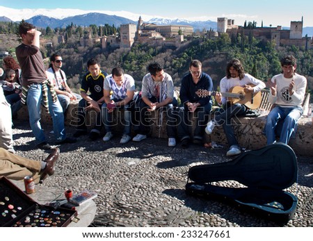 GRANADA, SPAIN, MARCH 7: Flamenco street musicians entertaining people with flamenco music in Granada, Spain on 7 March 2009. They have got as background the Alhambra Palace