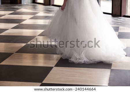 Bride starting her walk over a shinny chequered floor