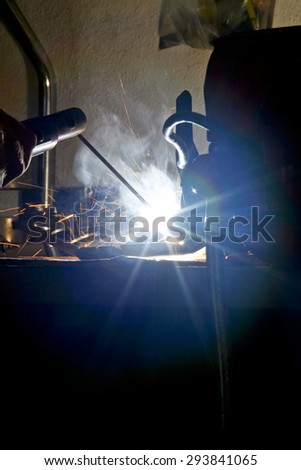 Detail of welding ray lights over dark background