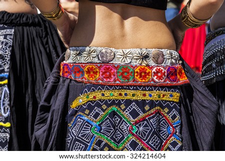 Belly dancer back with colored skirt full of decoratives details