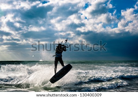 KITE BOARDING. Kite surfer jumping.