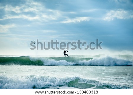 KITE BOARDING. Kite surfer in waves.