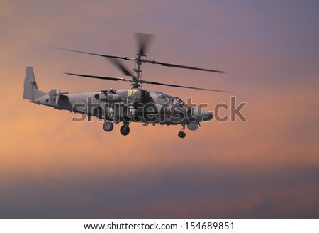 Attack helicopter in red sky