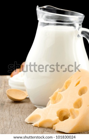 milk products and cheese isolated on black background