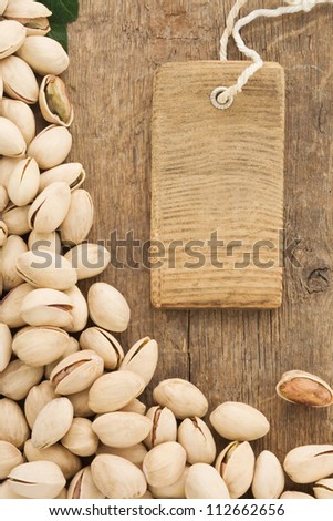 pistachios nuts and tag price label on wood background