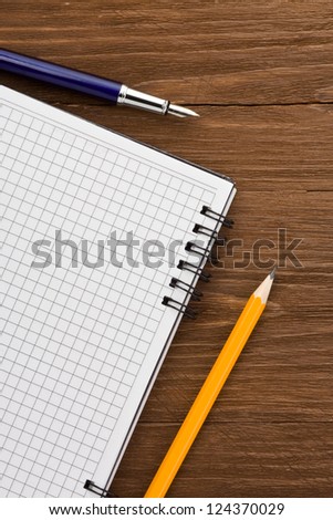 checked notepad  on wood background
