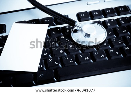 stethoscope and blank at keyboard background