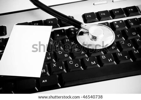 stethoscope and blank at keyboard background