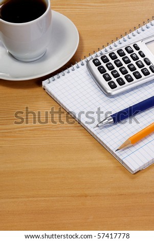 notepad and coffee at table