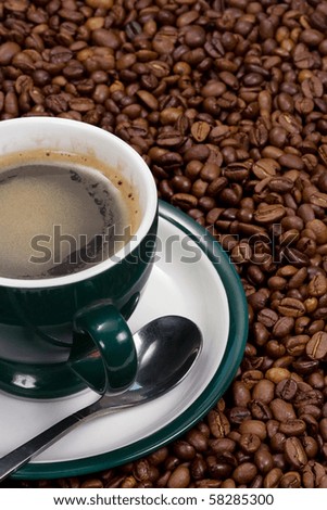 green cup of coffee and beans