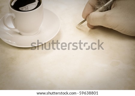 sepia image of coffee and writing hand