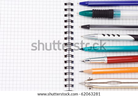 set of pens and pencils on pad