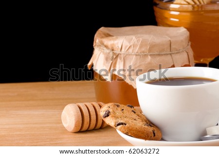 coffee, honey and cookies on black