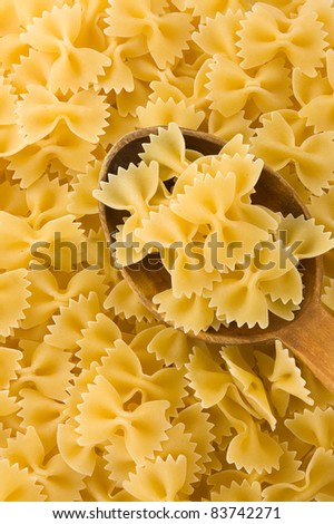 uncooked raw pasta and wood spoon