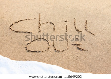 Chill out - written in the sand with a foamy wave underneath
