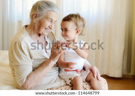 Portrait of 1,5 years old baby and and her 91,5 years old great grandmother